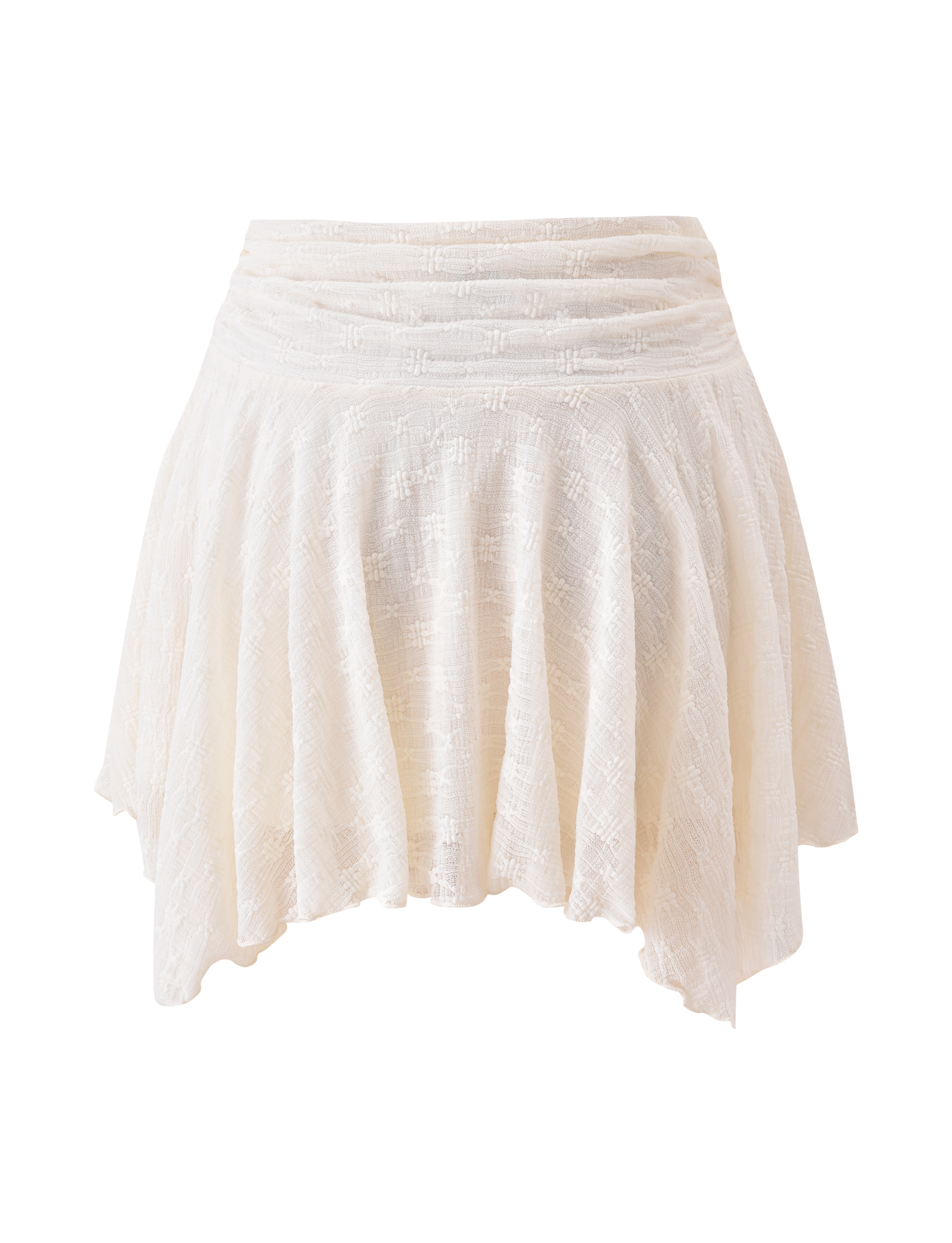 The TIGERMIST MYLAH MINI SKIRT in ivory features eyelet lace, a ruched waistband, and an asymmetrical handkerchief hem, shown on a plain background.