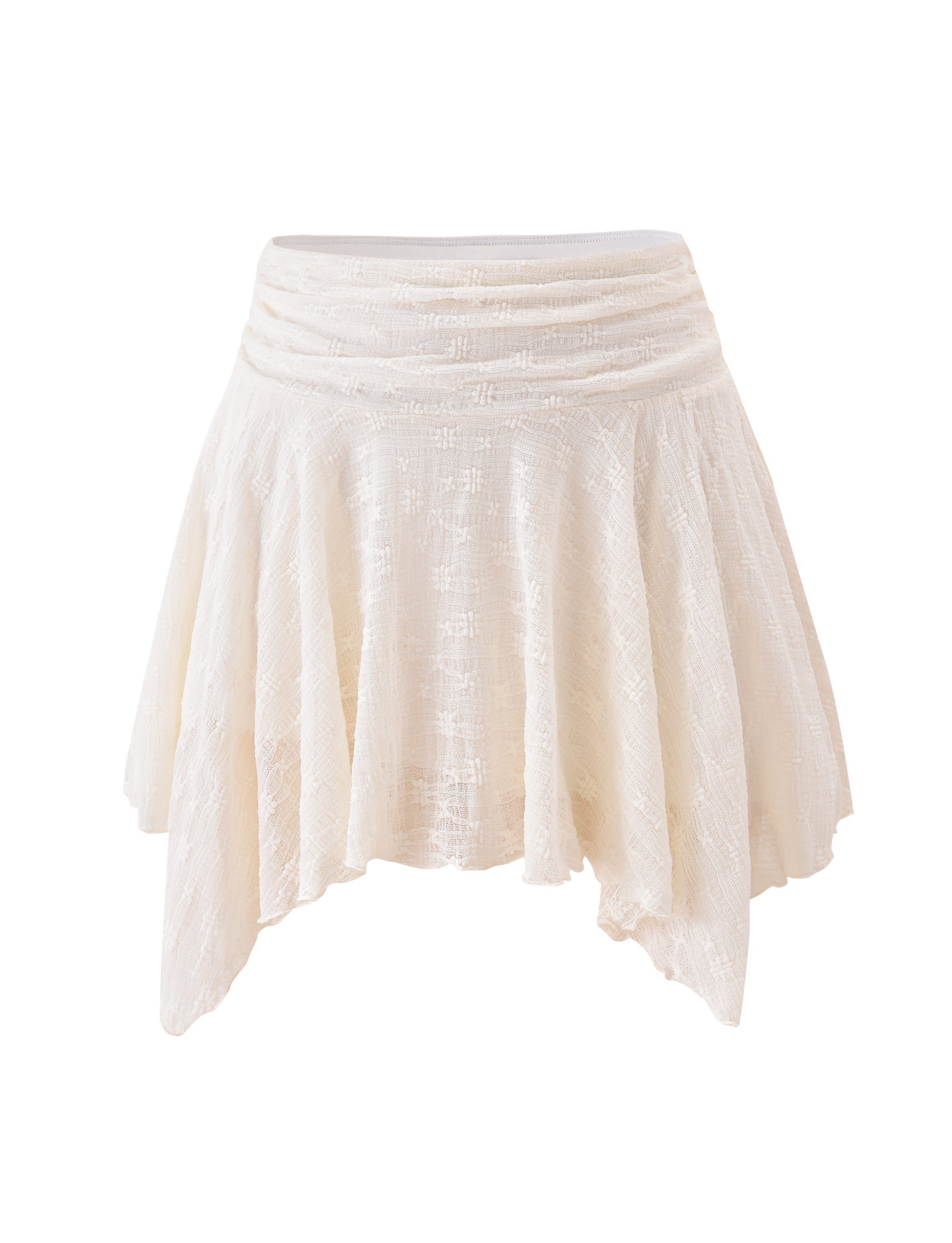 The TIGERMIST MYLAH MINI SKIRT in ivory showcases eyelet lace, a textured A-line silhouette, an asymmetrical handkerchief hem, and a gathered waistband, set against a plain white background.