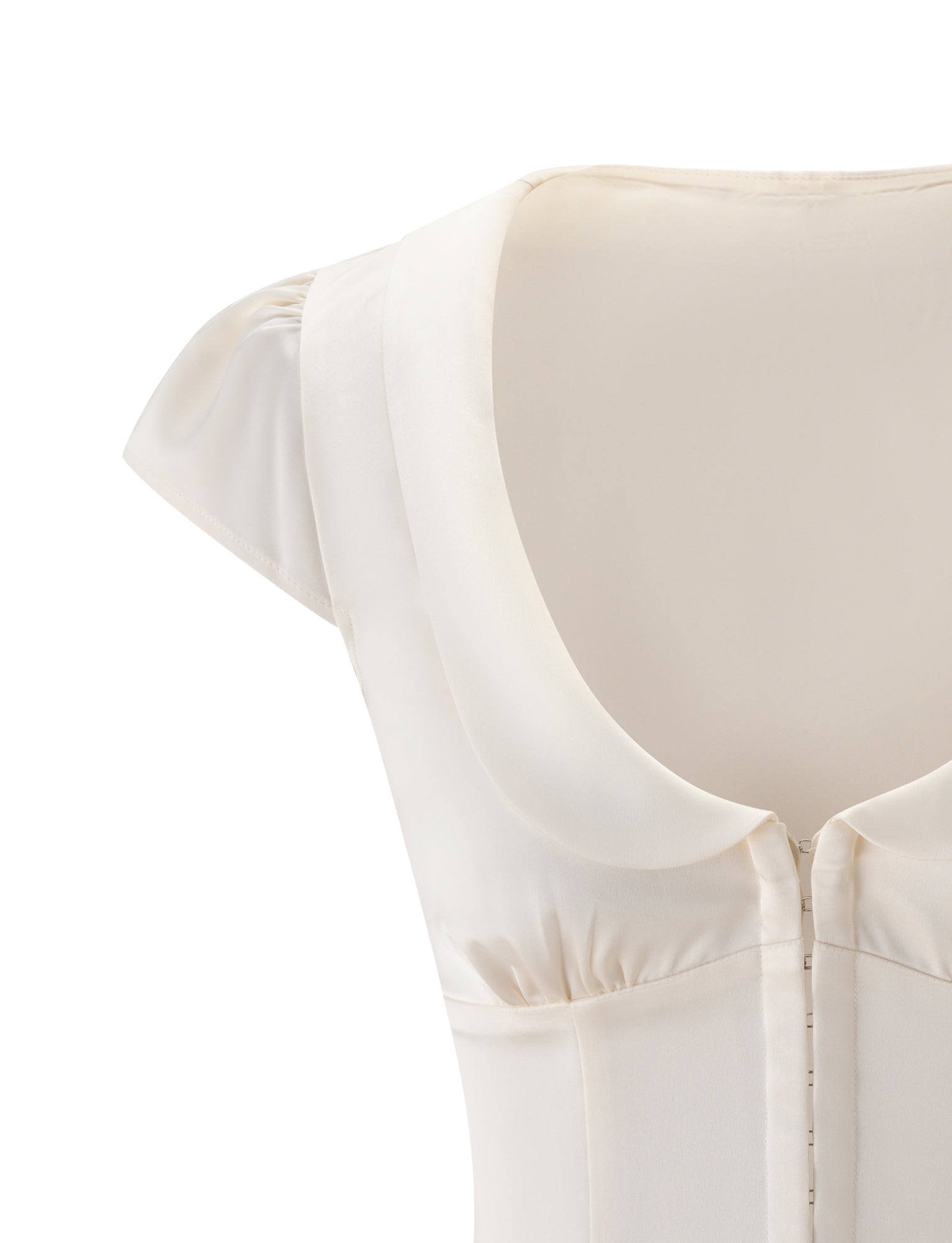 Introducing the MAURA TOP in WHITE by TIGERMIST—a cream-colored top featuring cap sleeves, a rounded collar, and elegant princess seams for added shape. The upper part and zipper closure are visible against a white background.