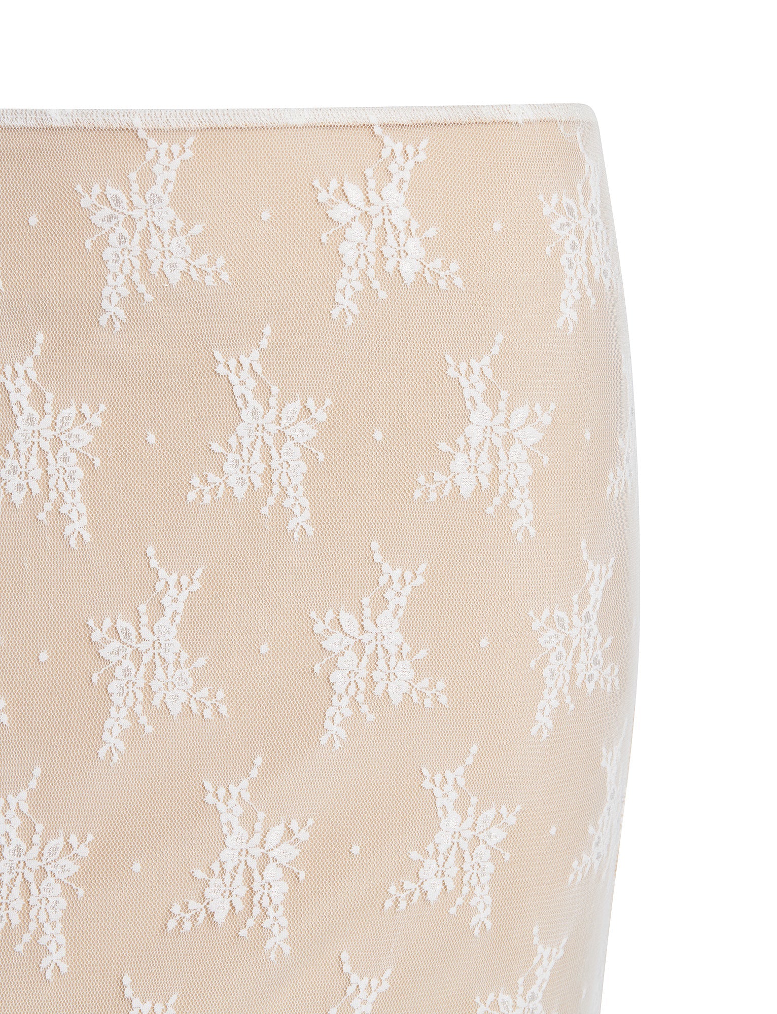 Close-up of the Karolina Skirt from TigerMist, crafted from sheer beige fabric and adorned with delicate white lace embroidery. The intricate lace design features small flowers arranged symmetrically, creating a detailed and elegant pattern.