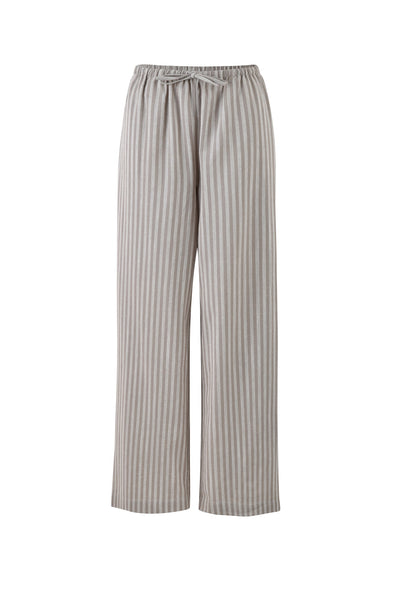 The LAINEY PANT - GREY : STRIPE from TIGERMIST are loose-fitting, wide-legged pants featuring vertical beige and white stripes. They come with an elastic waistband and a drawstring for adjustable fit but do not have visible pockets or additional features.