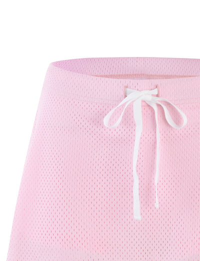 Close-up of the NYDIA SKORT - PINK : BLUSH : DUSTY PINK from TIGERMIST, featuring a light pink mesh fabric with an elastic waistband. The waistband includes a white drawstring tied in a bow at the center front. The coarse, perforated mesh texture gives this skort a casual and sporty appearance.